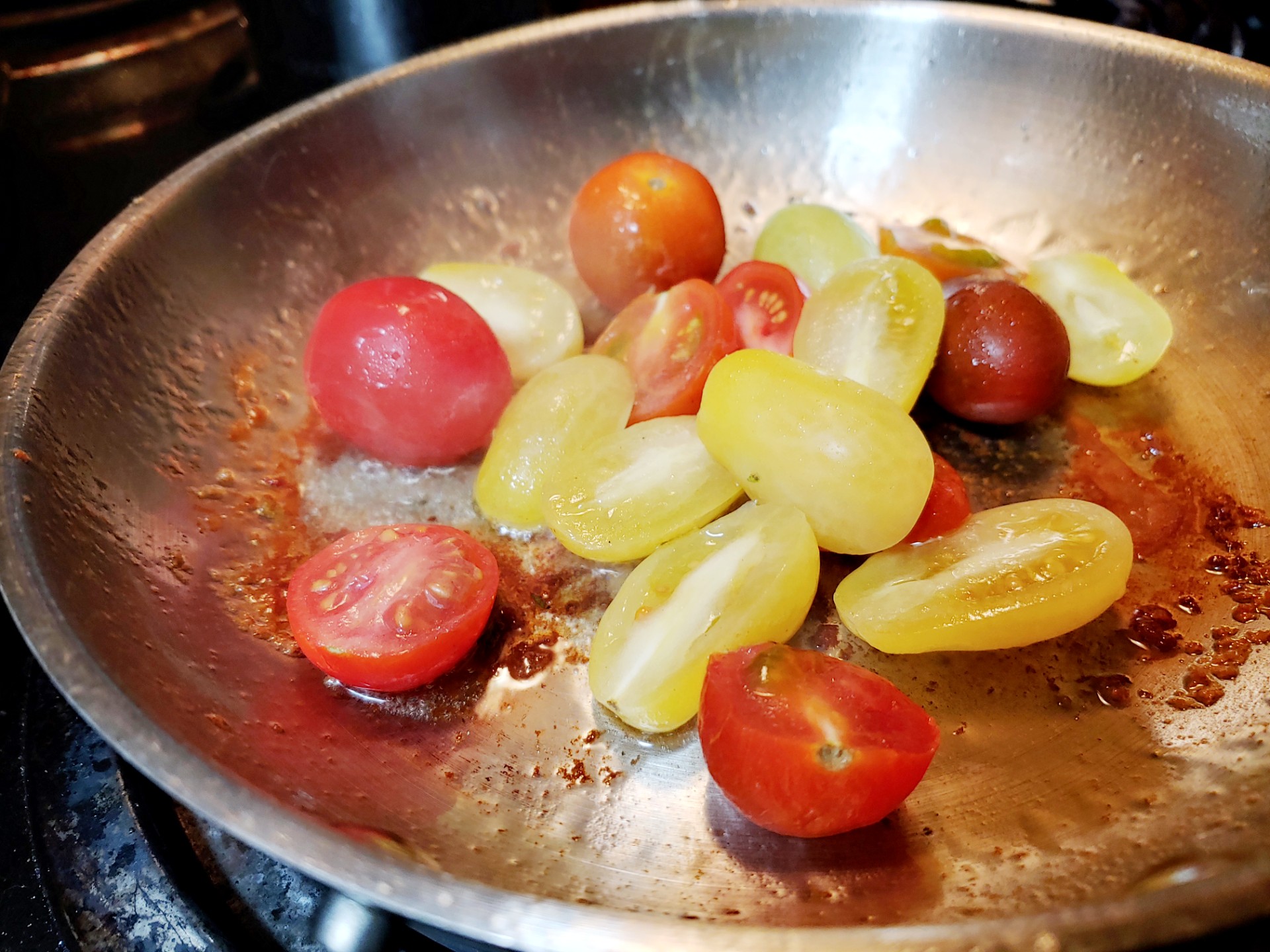 searing halved tomatoes in pan