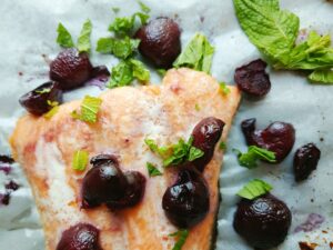 paleo baked salmon with cherries and mint close up
