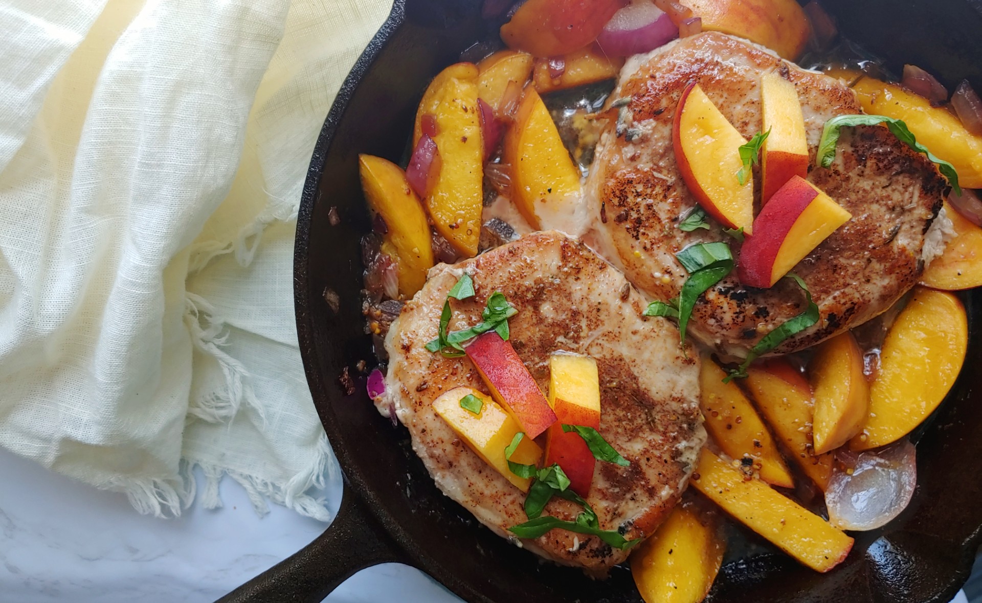 peaches and pork chops with basil in cast iron