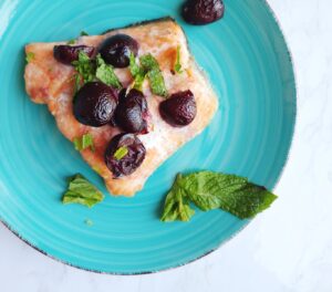 plate baked salmon with cherries and mint