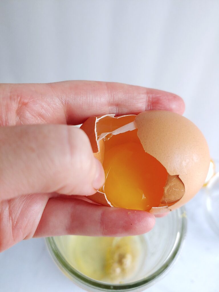 add the cracked egg to the jar