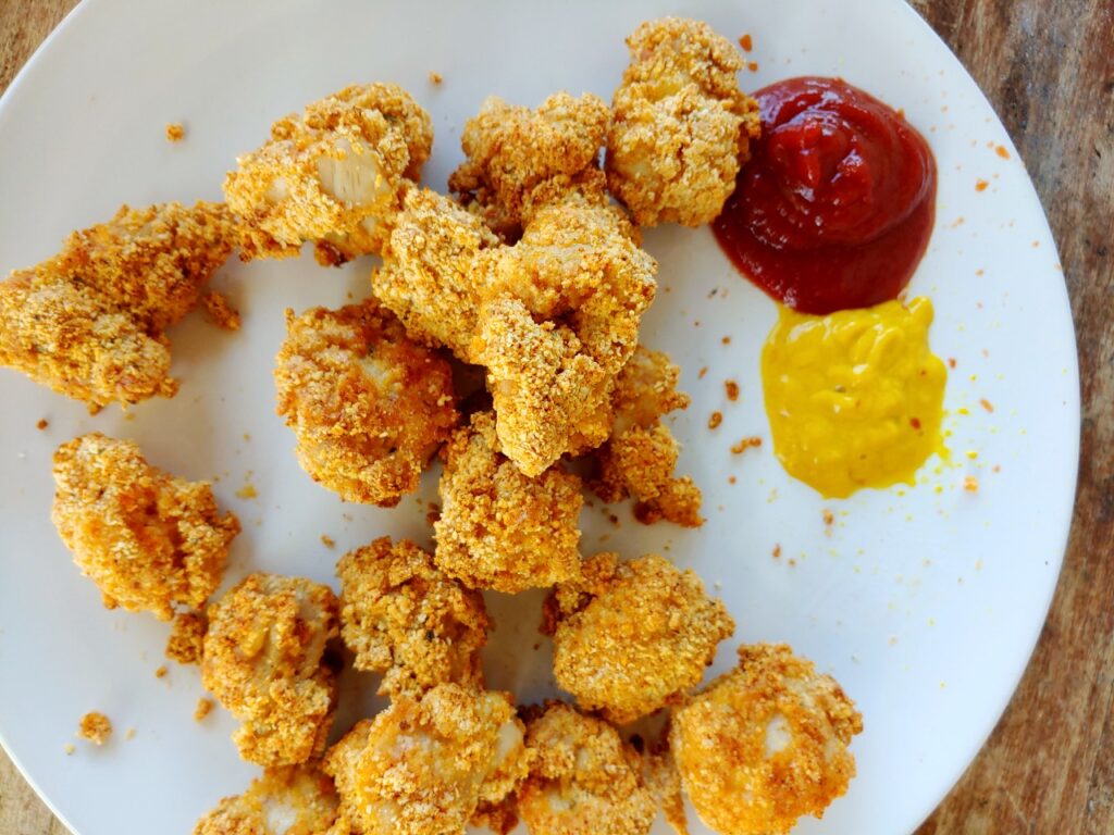whole30 air fryer chicken nuggets on plate with mustard and ketchup