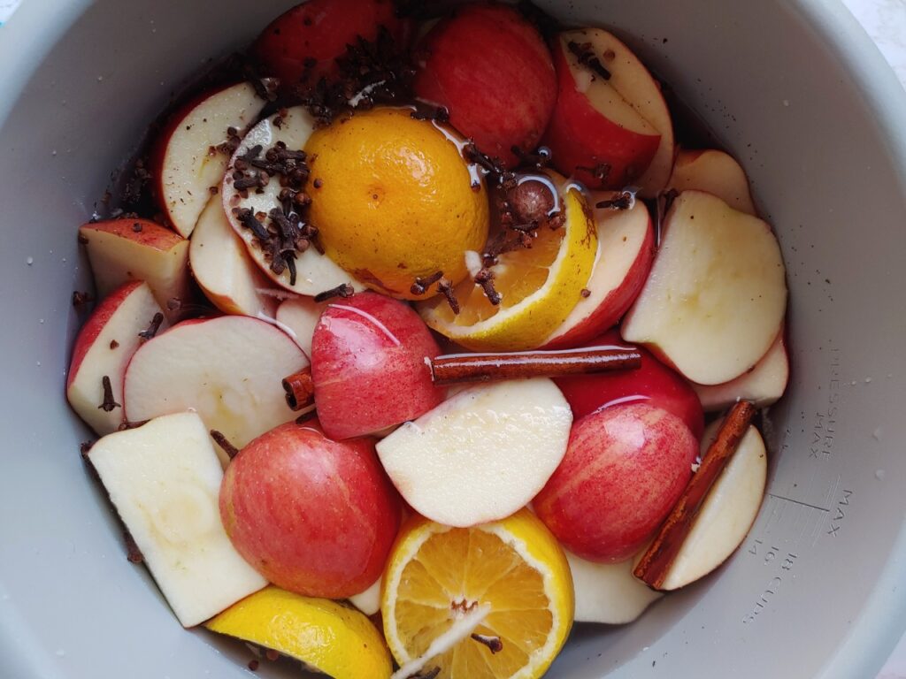 apples, oranges, and whole spices in instant pot or ninja foodi pot with water