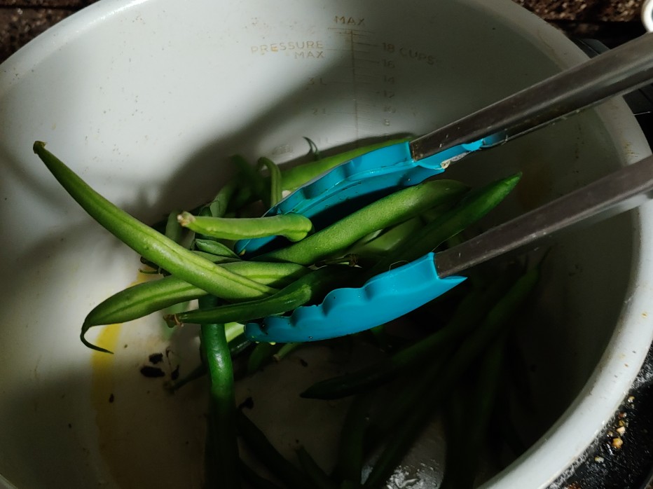 tossing green beans in chicken fat in ninja foodi basket